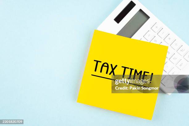 tax time - notification of the need to file tax form and calculator. - tax time stock pictures, royalty-free photos & images
