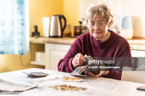 close-up of a senior woman counting money in european union currency - armoede stockfoto's en -beelden