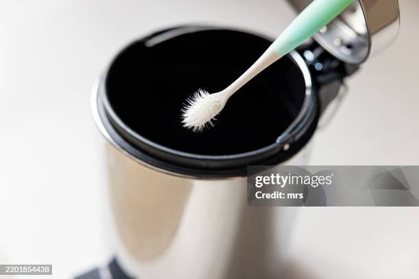 throwing away used toothbrush - toothbrush stock pictures, royalty-free photos & images