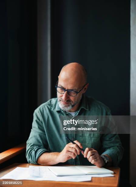 businessman working thoughtfully at desk in an office setting - to do list stock pictures, royalty-free photos & images