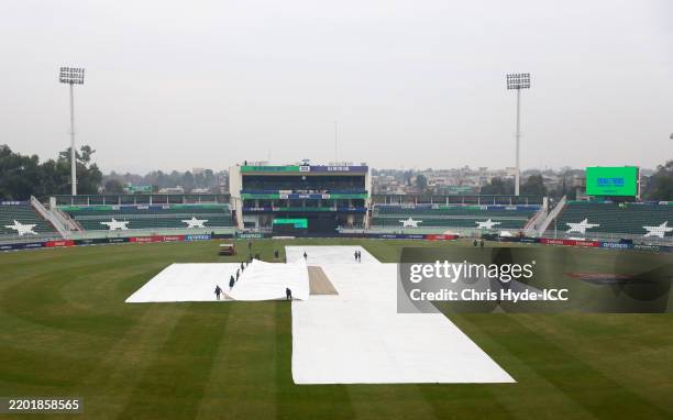 General view inside the stadium as covers are seen over the field ahead of the ICC Champions Trophy 2025 match between Australia and South Africa at...