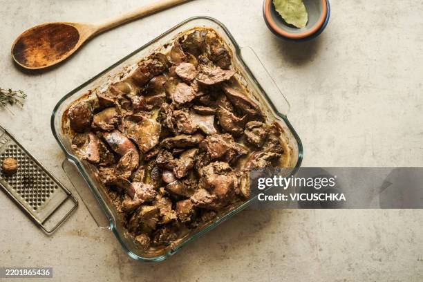 cooked chicken livers in casserole on kitchen table background - offal stock pictures, royalty-free photos & images