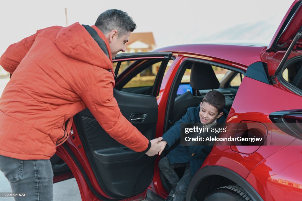 Affectionate Uncle Assisting Nephew Getting Out of Car Looking Joyful and Happy