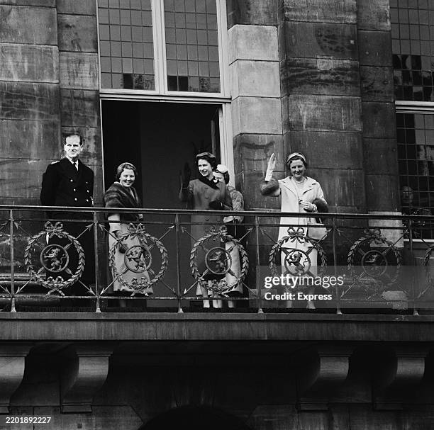 Prince Philip, Princess Beatrix of the Netherlands, Elizabeth II and Queen Juliana of the Netherlands smiling on a balcony during Elizabeth's state...