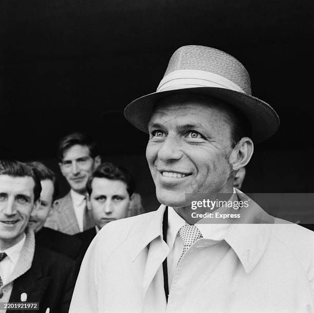 Jazz singer and actor Frank Sinatra smiles while at London Airport, June 8th 1958.