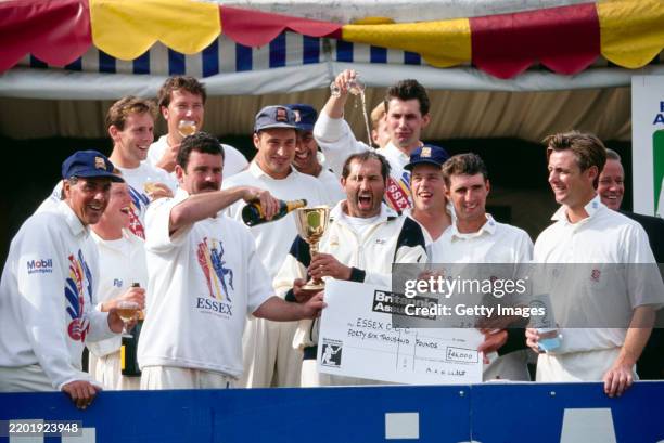 Essex players celebrate after winning the 1992 Britannic Assurance County Championship, captain Graham Gooch has a drink poured over his head by Neil...
