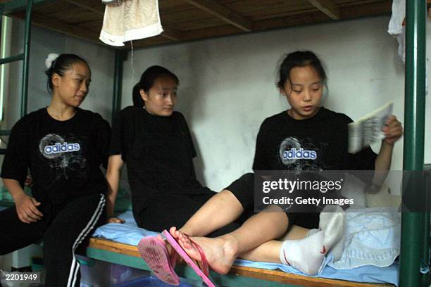 Female students hang out in their dormitory before the beginning of daily afternoon training at the state owned Shichahai sports school July 25, 2003...