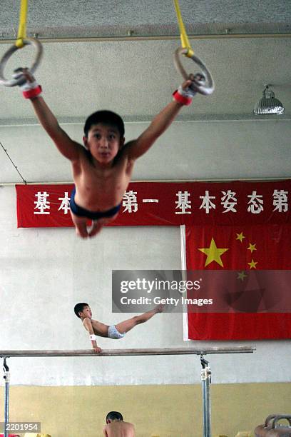 Students practice their daily training at the state owned Shichahai sports school July 25, 2003 in Beijing, China. The school is one of China's most...