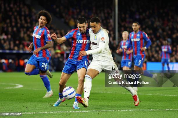 Jacob Ramsey of Aston Villa is challenged by Daniel Munoz of Crystal Palace during the Premier League match between Crystal Palace FC and Aston Villa...