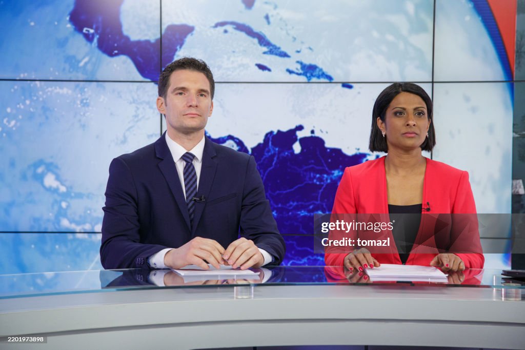 Journalists preparing in a tv news studio