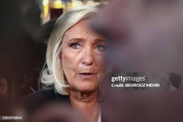 French far-right Rassemblement National Member of Parliament Marine Le Pen looks on as she visits the 61st International Agricultural Fair at the...