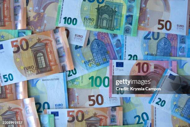 euro banknotes spread out in a flat lay - european union euro note stock pictures, royalty-free photos & images