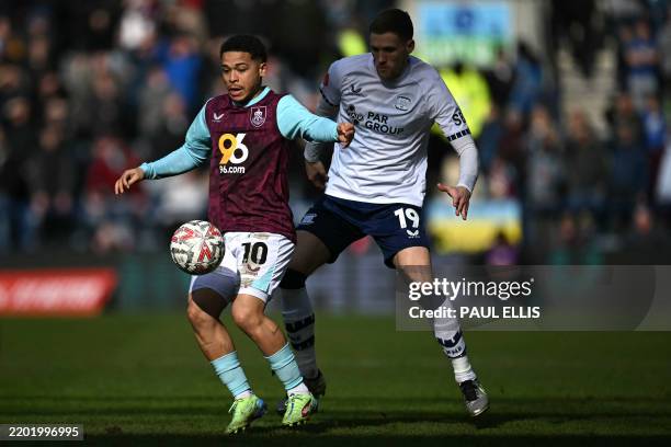 Burnley's Belgian midfielder Manuel Benson battles for the ball with Preston's English defender Lewis Gibson during the English FA Cup fifth round...