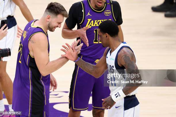 Luka Doncic of the Los Angeles Lakers greets Kyrie Irving of the Dallas Mavericks during the first half of a game at Crypto.com Arena on February 25,...