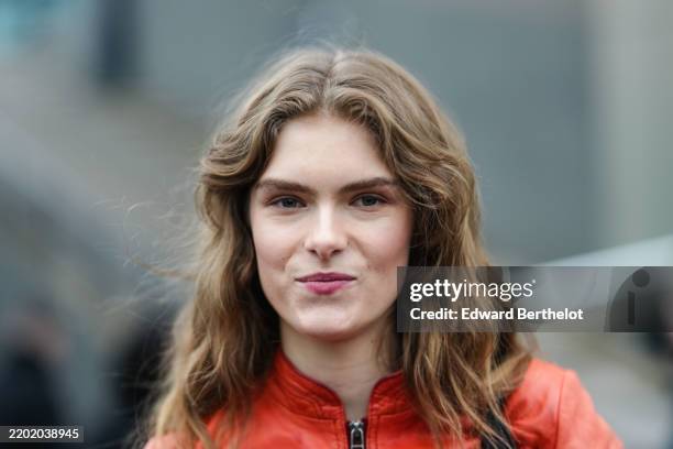 Guest wears a red leather jacket, outside Gucci, during the Milan Fashion Week Womenswear Fall/Winter 2025/2026 on February 25, 2025 in Milan, Italy.