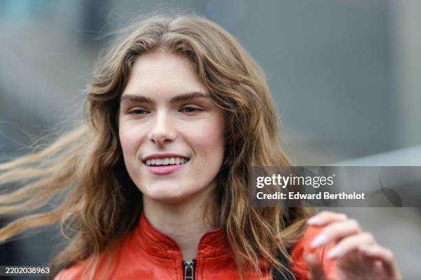 Guest wears a red leather jacket, outside Gucci, during the Milan Fashion Week Womenswear Fall/Winter 2025/2026 on February 25, 2025 in Milan, Italy.