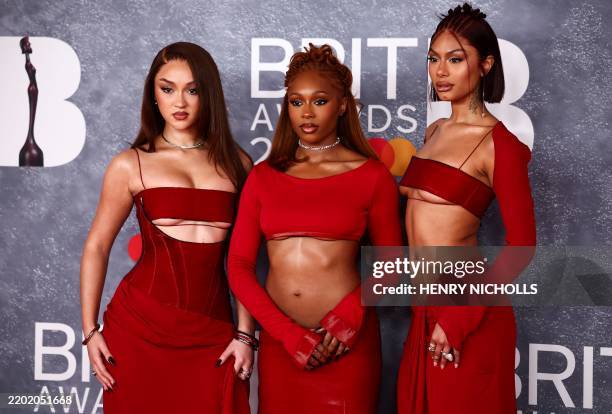 British group FLO composed by Stella Quaresma, Renee Downer and Jorja Douglas pose on the red carpet upon arrival for the BRIT Awards 2025 in London...