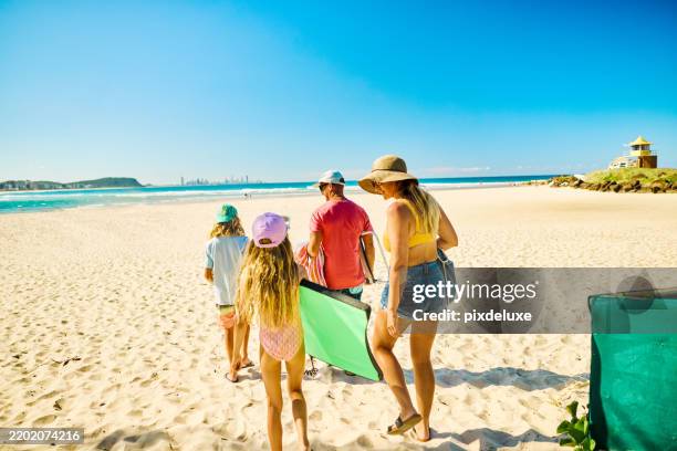 family walking to the beach in australia for summer vacations - gold coast australia stock pictures, royalty-free photos & images