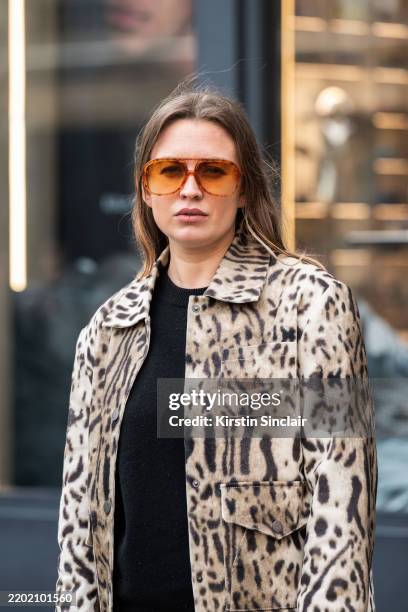 Harriet Nicolson wears a Revolve jacket, Valley sunglasses and a black jumper during London Fashion Week February 2025 at the Bora Aksu show on...