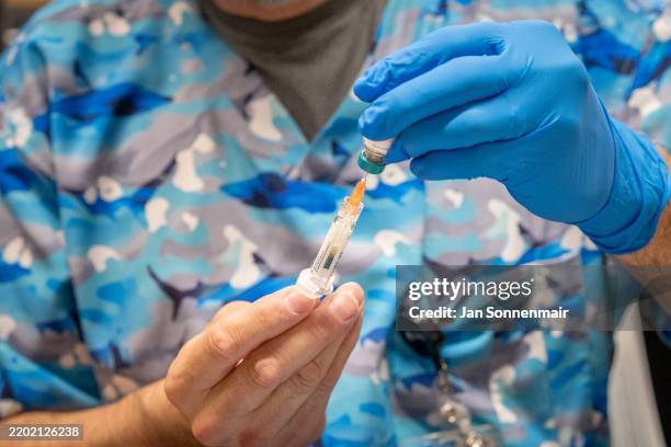 Raynard Covarrubio fills a syringe with the MMR vaccine, at a vaccine clinic put on by Lubbock Public Health Department on March 1, 2025 in Lubbock,...