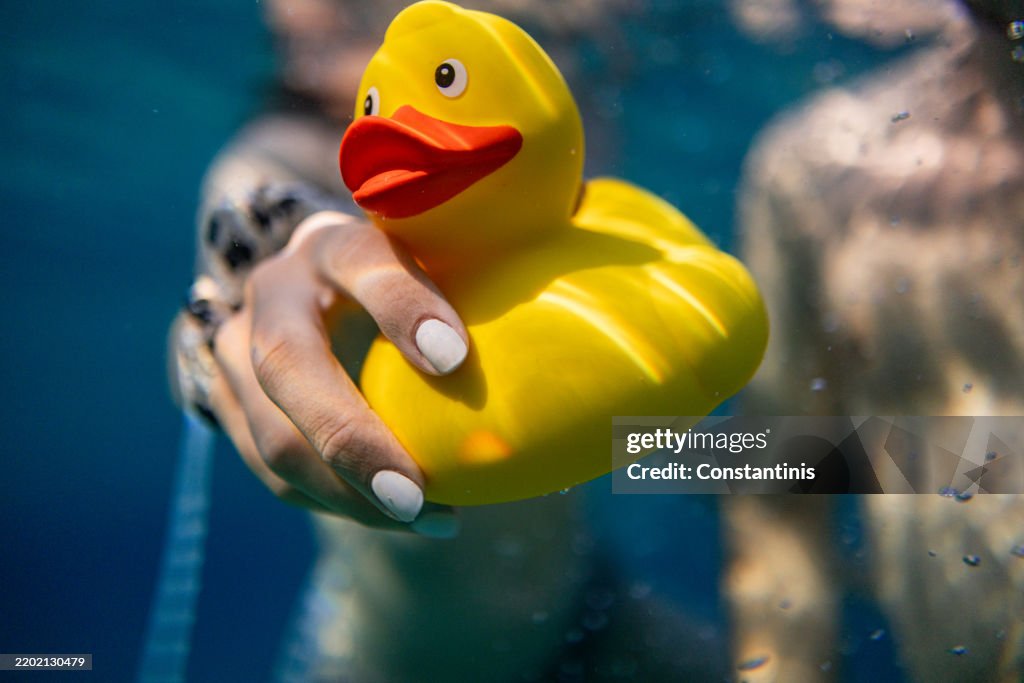 A yellow rubber duck toy floating in the sea