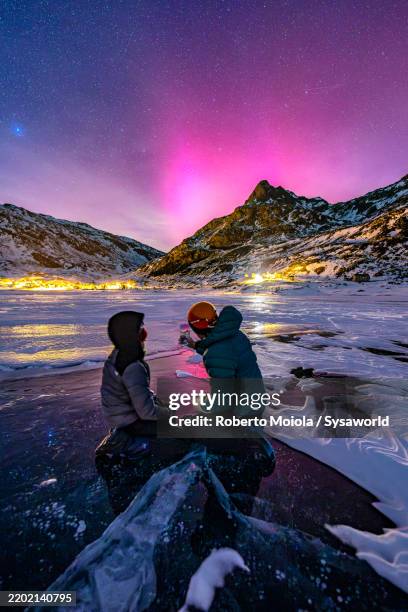 happy boy with father watching the northern lights - aurora borealis stock pictures, royalty-free photos & images
