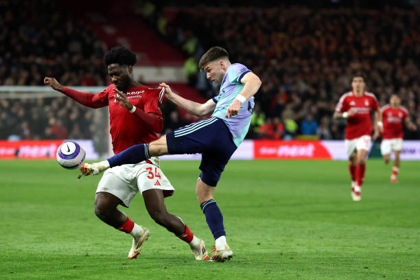 Kieran Tierney of Arsenal clears the ball whilst under pressure from Ola Aina of Nottingham Forest during the Premier League match between Nottingham...