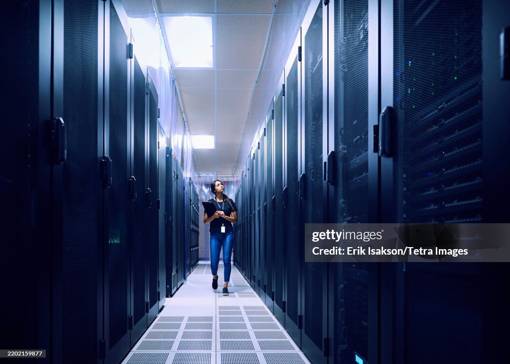 Female technician walking in server room