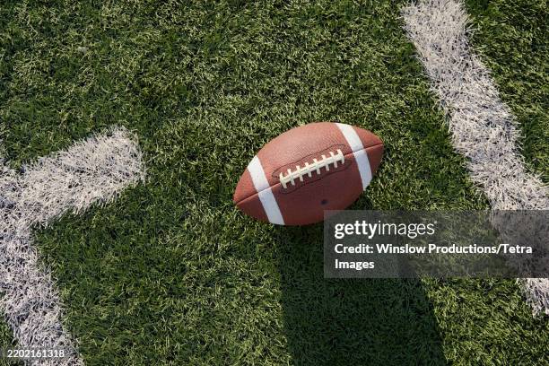 overhead view of american football ball in field - futebol americano imagens e fotografias de stock