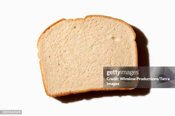 overhead view of slice of white bread on white background - white bread stock pictures, royalty-free photos & images