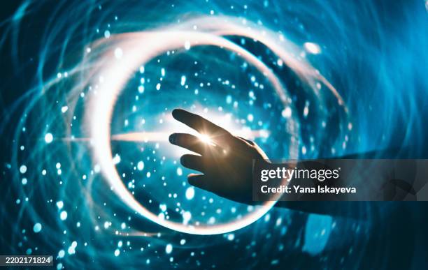 a human hand reaching out to the dark unknown, the dark matter - infinità foto e immagini stock