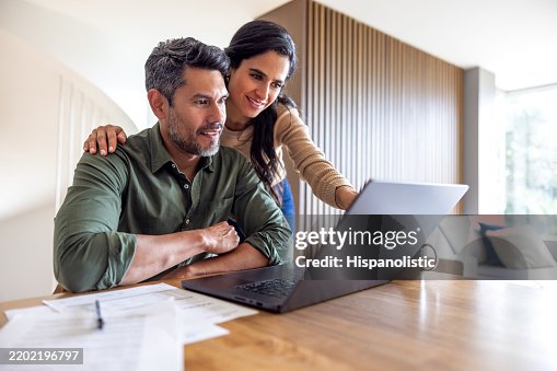 Loving couple organizing their home finances Loving couple organizing their home finances