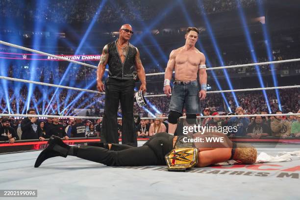 Dwayne "The Rock" Johnson and John Cena stand over Cody Rhodes during WWE Elimination Chamber at Rogers Centre on March 1, 2025 in Toronto, Canada.