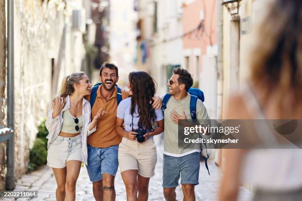 cheerful tourists having fun while walking on the street. - conforto imagens e fotografias de stock