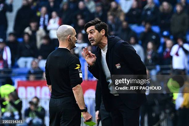 Lyon's Portuguese head coach Paulo Fonseca talks to French referee Benoit Millot during the French L1 football match between Olympique Lyonnais and...