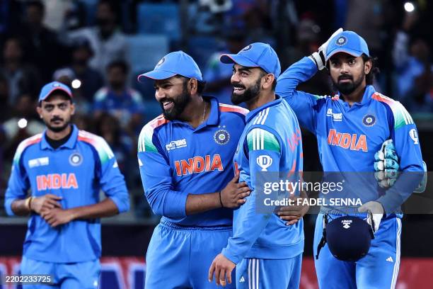 India's captain Rohit Sharma and his teammate Virat Kohli celebrate their team's win in the ICC Champions Trophy one-day international cricket match...