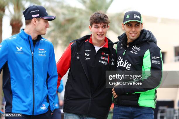 Jack Doohan of Australia and Alpine F1 looks on as Oliver Bearman of Great Britain and Haas F1 and Gabriel Bortoleto of Brazil and Stake F1 Team Kick...