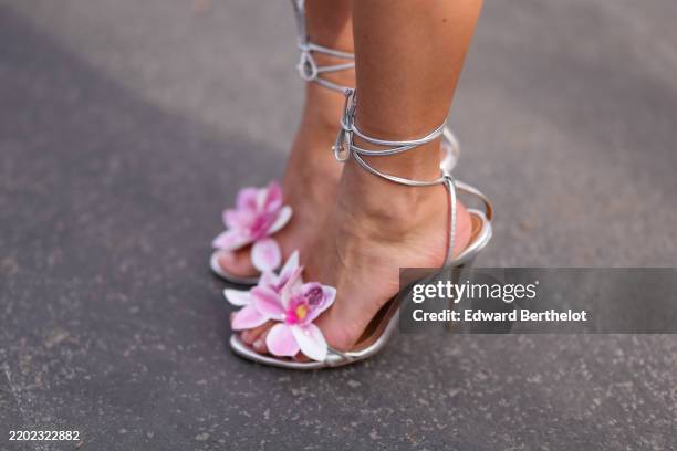Chloe Lecareau wears silver metallic light pink floral detail strappy open toe heels leather shoes, outside Diesel, during the Milan Fashion week...