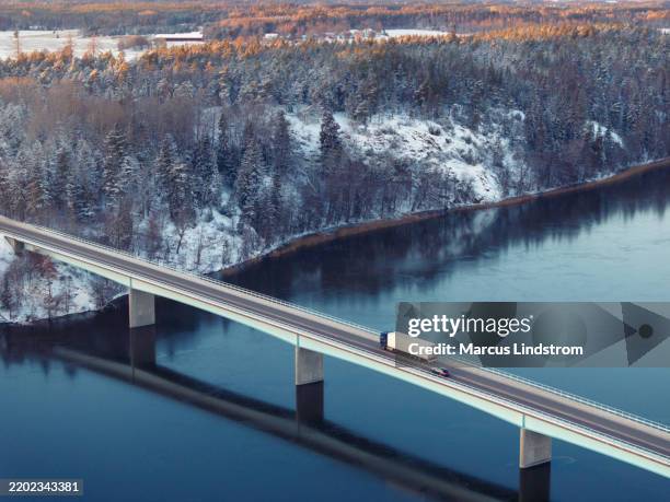 truck crossing a highway bridge in winter - scandinavia stock pictures, royalty-free photos & images