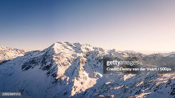 majestic alpine peak under winter sun bormio,italy - bormio foto e immagini stock