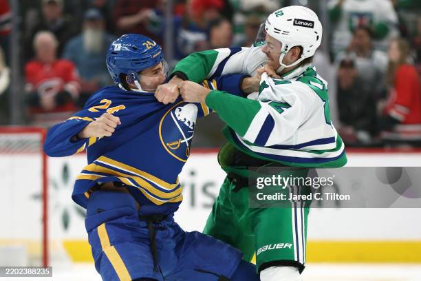 Jesperi Kotkaniemi of the Carolina Hurricanes and Dylan Cozens of the Buffalo Sabres are involved in a fight during the first period of the game at...