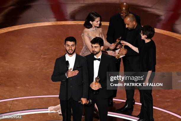 Israeli journalist and filmmaker Yuval Abraham and Palestinian journalist and filmmaker Basel Adra accept the award for Best Documentary Feature for...
