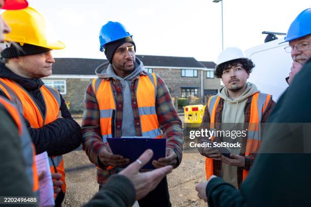 workers preparing for a construction task - apprentice builder stock pictures, royalty-free photos & images