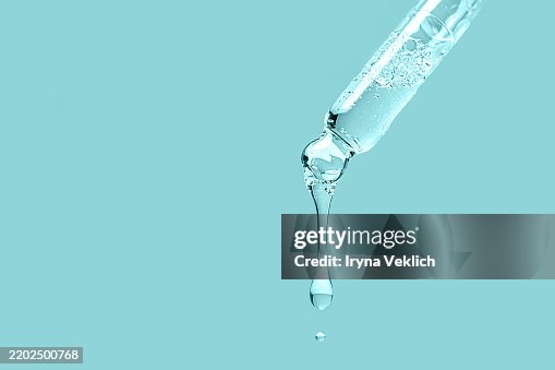 Natural Cosmetic and Liquid of Beauty Product for Body and Face Care Face Serum, Beauty Product Ampule in Glass Pipette with Drop and shadow in turquoise blue color background. Natural Cosmetic and Liquid of Beauty Product for Body and Face Care Face Serum, Beauty Product Ampule in Glass Pipette with Drop and shadow in turquoise blue color background.