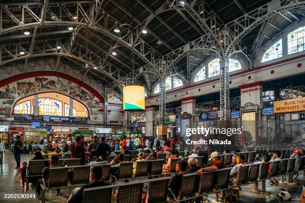 busy interior of mumbai train station with travelers and architectural details - indian railway ticket stock pictures, royalty-free photos & images