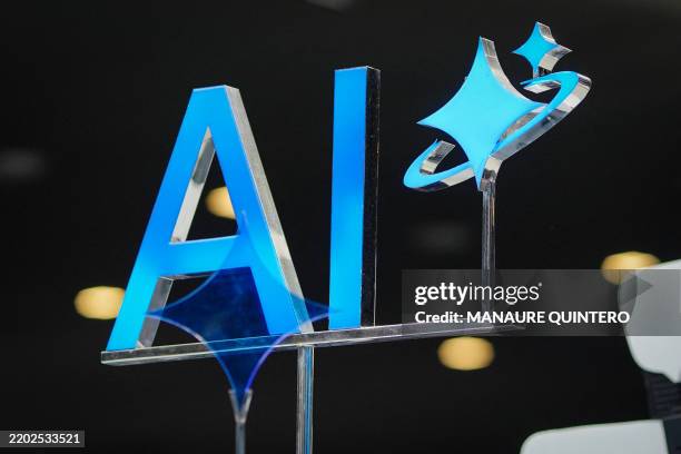 An AI sign is displayed during the MWC , the world's biggest mobile fair, in Barcelona on March 3, 2025. Surrounded by investment and innovation...
