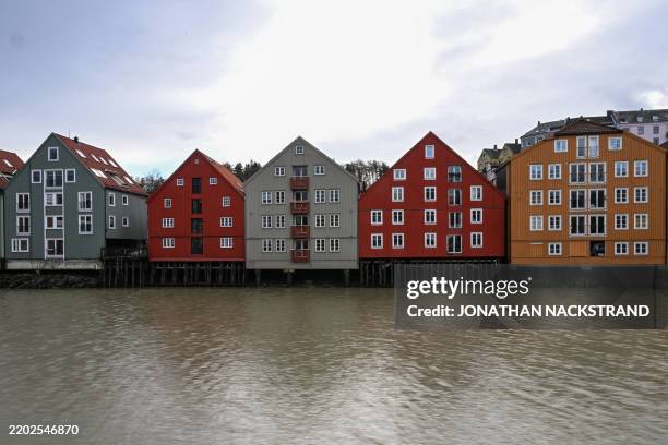The "Bryggen", historic wooden warehouses along the Nidelva River, are pictured on March 3, 2025 in Trondheim, Norway. These colourful buildings,...