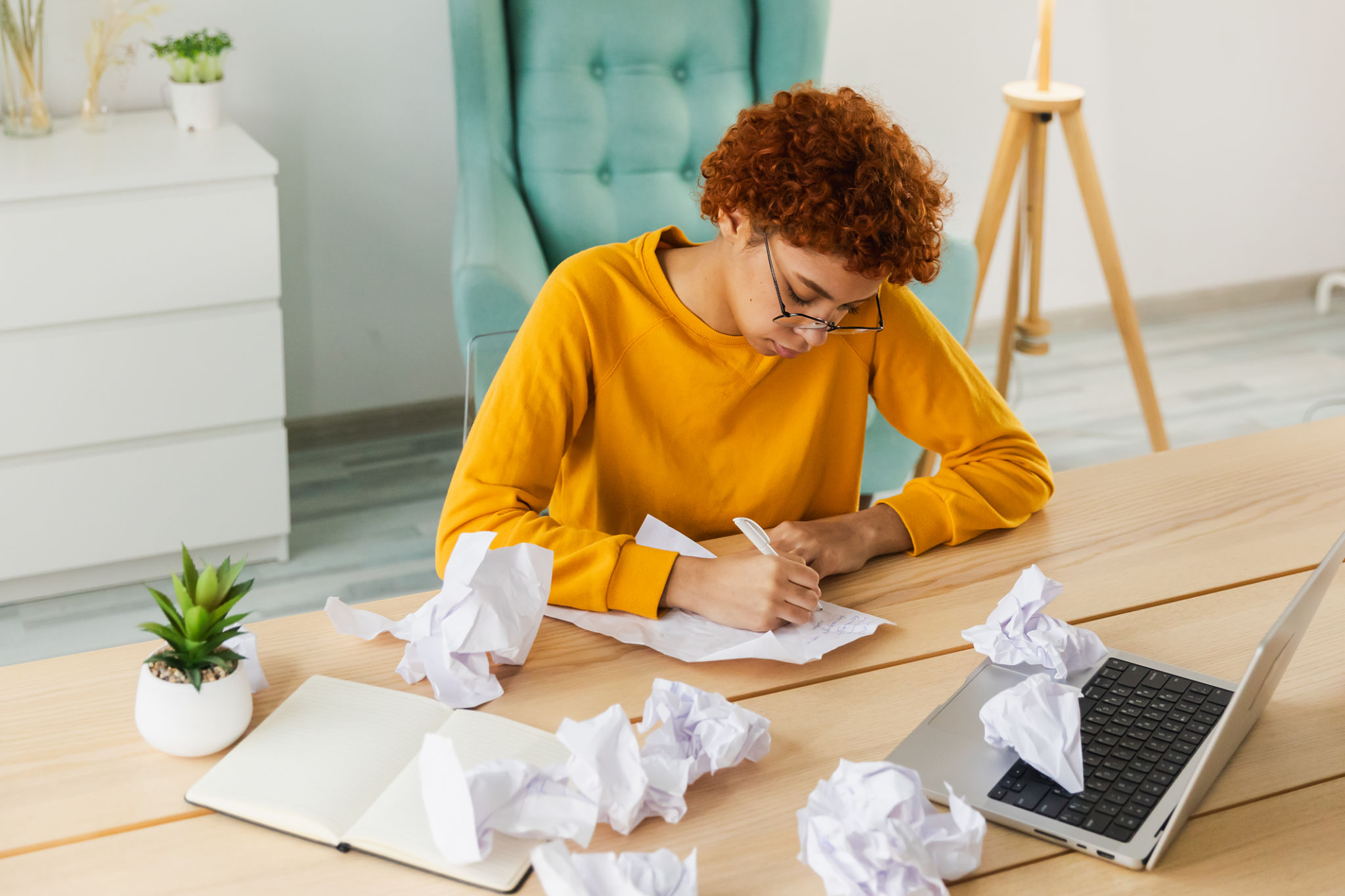 Serious African woman with crumpled paper having problem writing by hand document studying learning at home. Girl no idea sitting at workplace writing notes at office. Start up business deadline. Serious African woman with crumpled paper having problem writing by hand document studying learning at home. Girl no idea sitting at workplace writing notes at office. Start up business deadline.