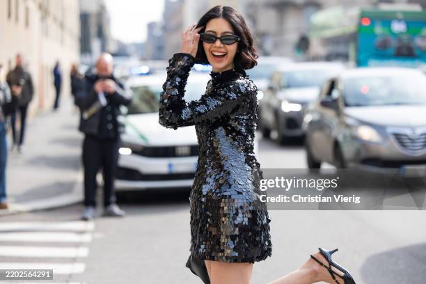 Proud Oranicha Krinchai wears black sequined dress, sunglasses outside Sportmax during the Milan Fashion Week Womenswear Fall/Winter 2025/2026 on...
