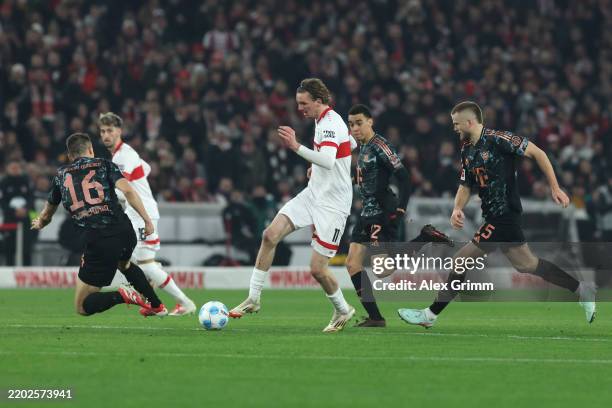 Nick Woltemade of VfB Stuttgart is challenged by Joao Palhinha during the Bundesliga match between VfB Stuttgart and FC Bayern München at MHPArena on...